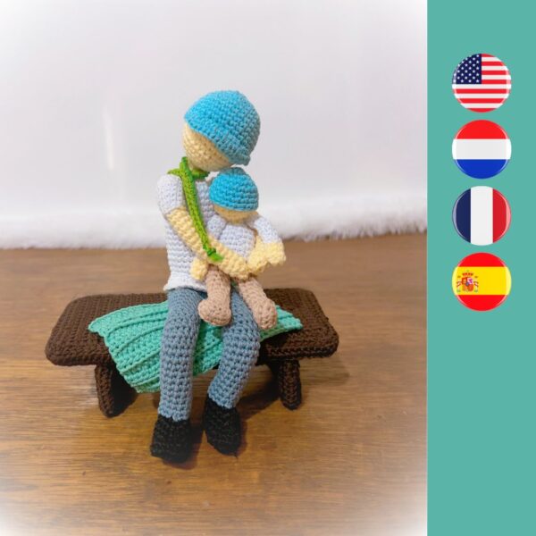 crochet father doll holding child and sitting on a crochet bench