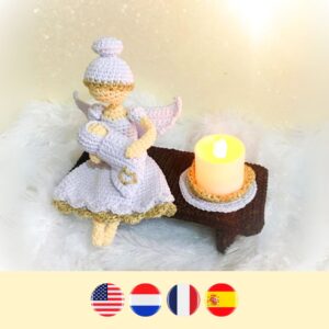 crochet memorial angel holding crochet baby with LED candle on bench