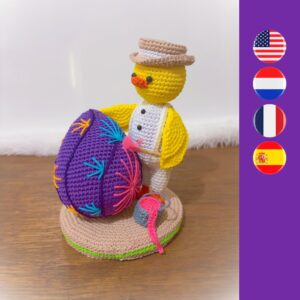 crochet Easter chick painting a crochet Easter egg