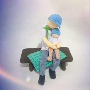 crochet father with child and blanket on bench
