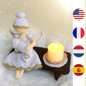 crochet memorial angel holding crochet baby with LED candle on bench