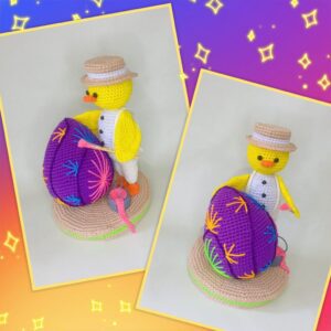 a crochet Easter chick painting an Easter egg