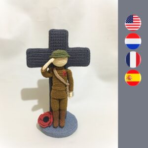 crochet soldier with poppy in front of crochet cross