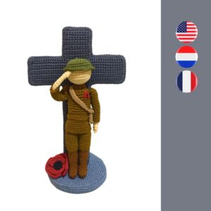 crochet soldier with poppy in front of crochet cross