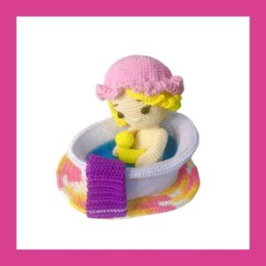 crochet doll taking a bath in crochet bath with towel and carpet
