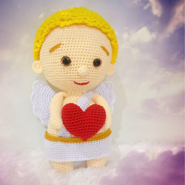 crochet Cupid holding crochet heart