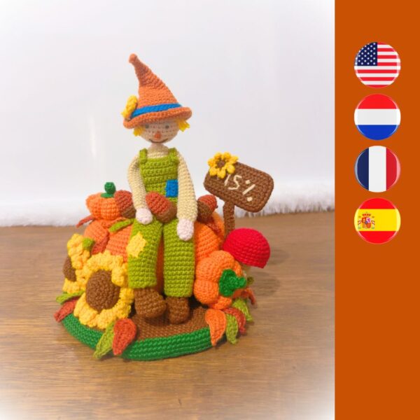 crochet scarecrow with crochet pumpkins, sunflowers, sign, leaves and a mushroom