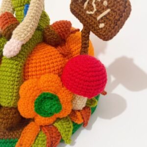 crochet scarecrow with crochet pumpkins, sunflowers, sign, leaves and a mushroom