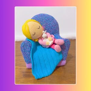 crochet doll napping in crochet sofa with blanket