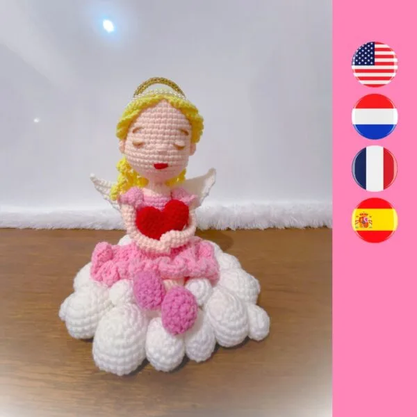 crochet angel holding crochet heart sitting on crochet cloud