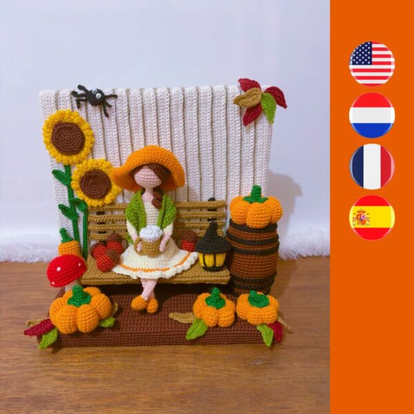 crochet Fall or Autumn decoration with a girl sitting on a bench drinking coffee, surrounded by pumpkins, mushroom, spider, barrel, sunflower