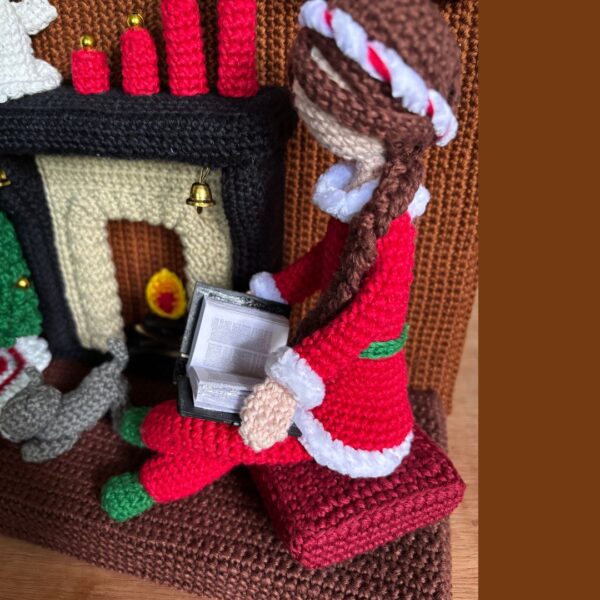 crochet lady doll in crochet living room with Christmas tree, cat, carpet, fireplace, cuckoo clock, Christmas wreath, candles