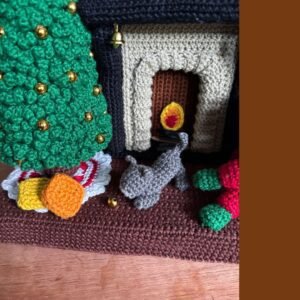 crochet lady doll in crochet living room with Christmas tree, cat, carpet, fireplace, cuckoo clock, Christmas wreath, candles