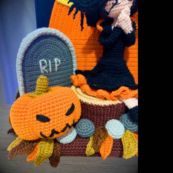 crochet halloween lady doll with crochet tree, gravestone, pumpkins, leaves, broom, moon, rocks and a ghost