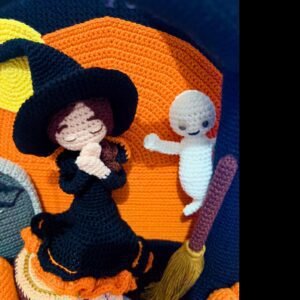 crochet halloween lady doll with crochet tree, gravestone, pumpkins, leaves, broom, moon, rocks and a ghost