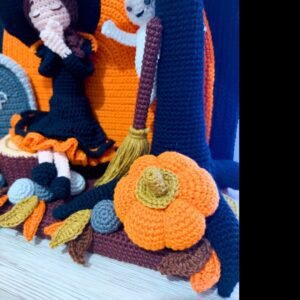 crochet halloween lady doll with crochet tree, gravestone, pumpkins, leaves, broom, moon, rocks and a ghost