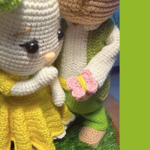 crochet Easter bunny boy and girl with butterflies, standing on a basket with grass in it