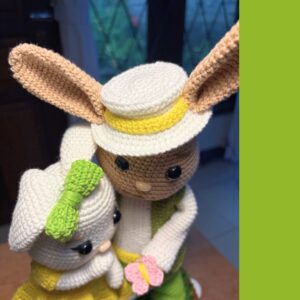 crochet Easter bunny boy and girl with butterflies, standing on a basket with grass in it